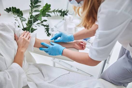 Clinical image of an IV being administered by a healthcare provider in a clean, modern setting